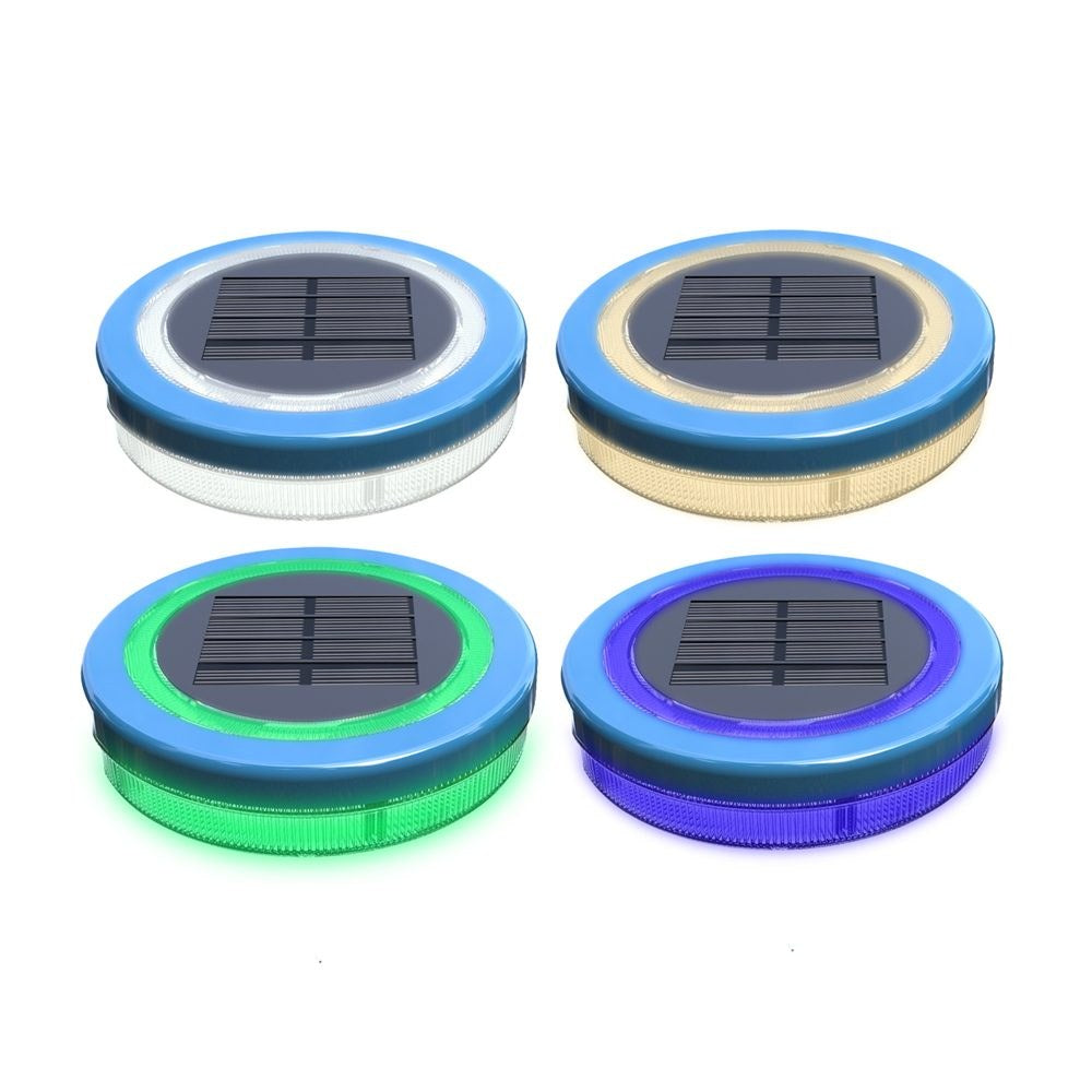 Mini floating solar pool light glowing warm white on water at night