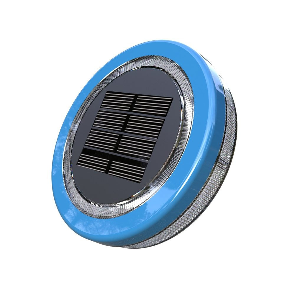 Mini floating solar pool light glowing warm white on water at night