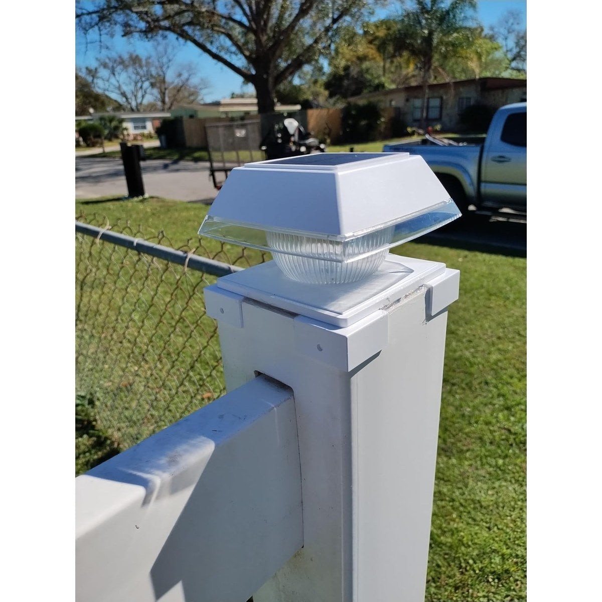 Solar post cap light on a timber fence post with adjustable colour