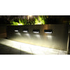 Aluminium solar wall light casting steady white light on an exterior wall