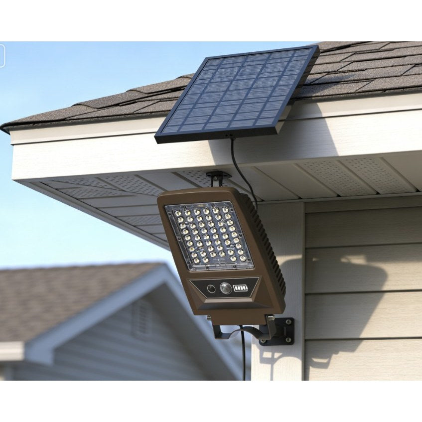 Solar flood light with detachable solar panel and PIR sensor on a shed wall