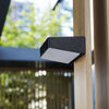 EV-WL-105 solar wall light beside a timber gate