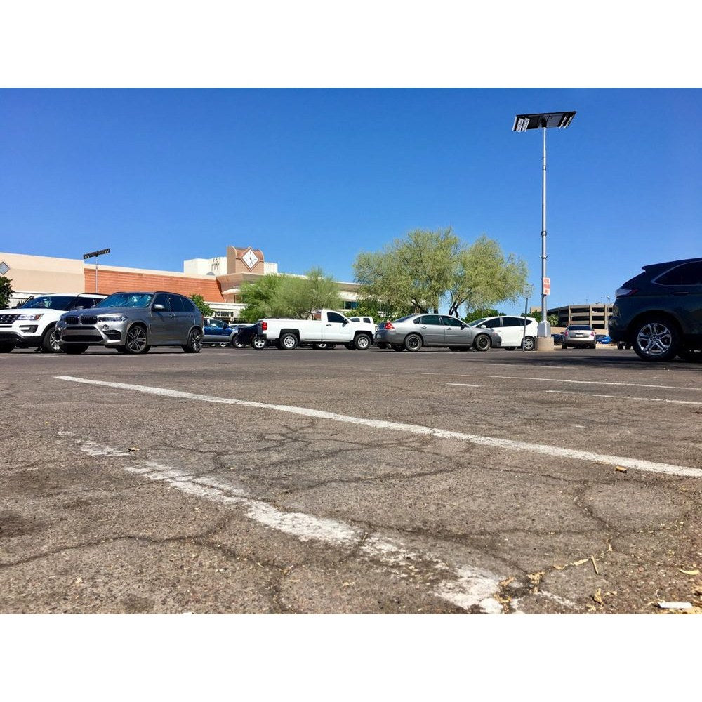 Double-sided solar parking lot light with four LED panels on a pole