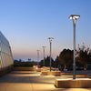 Row of EV-PZ-101 square post-top lights on a plaza at dusk