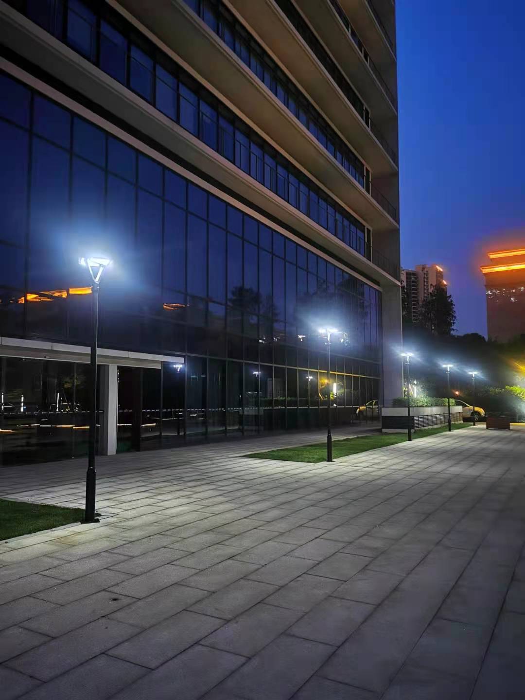 EV-PZ-101 square solar plaza lights along a building walkway