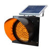 Solar powered flashing traffic warning light on a roadside pole