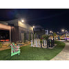 Solar courtyard light head on a short pole lighting a garden path