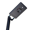 Solar courtyard light head on a short pole lighting a garden path