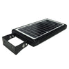 Solar courtyard light head on a short pole lighting a garden path