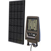 Solar flood light with detachable solar panel and PIR sensor on a shed wall