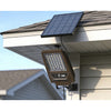 Solar flood light with detachable solar panel and PIR sensor on a shed wall