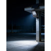 Solar flood light with detachable solar panel and PIR sensor on a shed wall