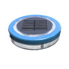 Mini floating solar pool light glowing warm white on water at night