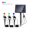 Three aluminium solar spot lights with shared solar panel lighting a garden