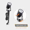 Three aluminium solar spot lights with shared solar panel lighting a garden