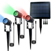 Three aluminium solar spot lights with shared solar panel lighting a garden