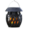 Solar flame-effect table lamp glowing on an outdoor dining table