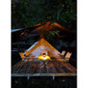 Solar flame-effect table lamp glowing on an outdoor dining table