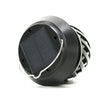 Solar flame-effect table lamp glowing on an outdoor dining table