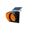 Solar powered flashing traffic warning light on a roadside pole