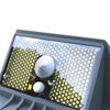 Butterfly-shaped solar wall light glowing in colour on a garden fence